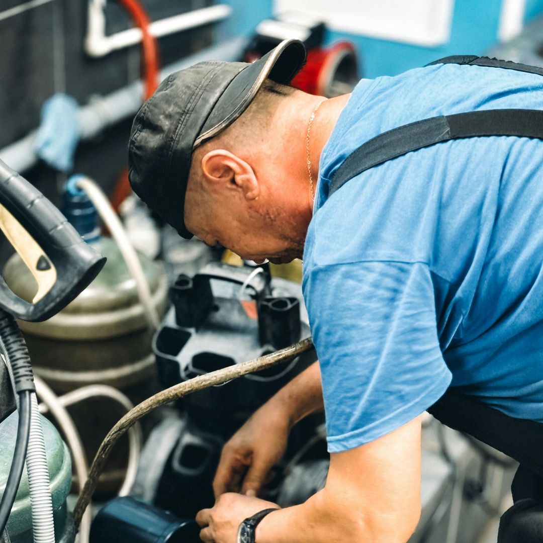 Technician repairing a shot blasting machine.